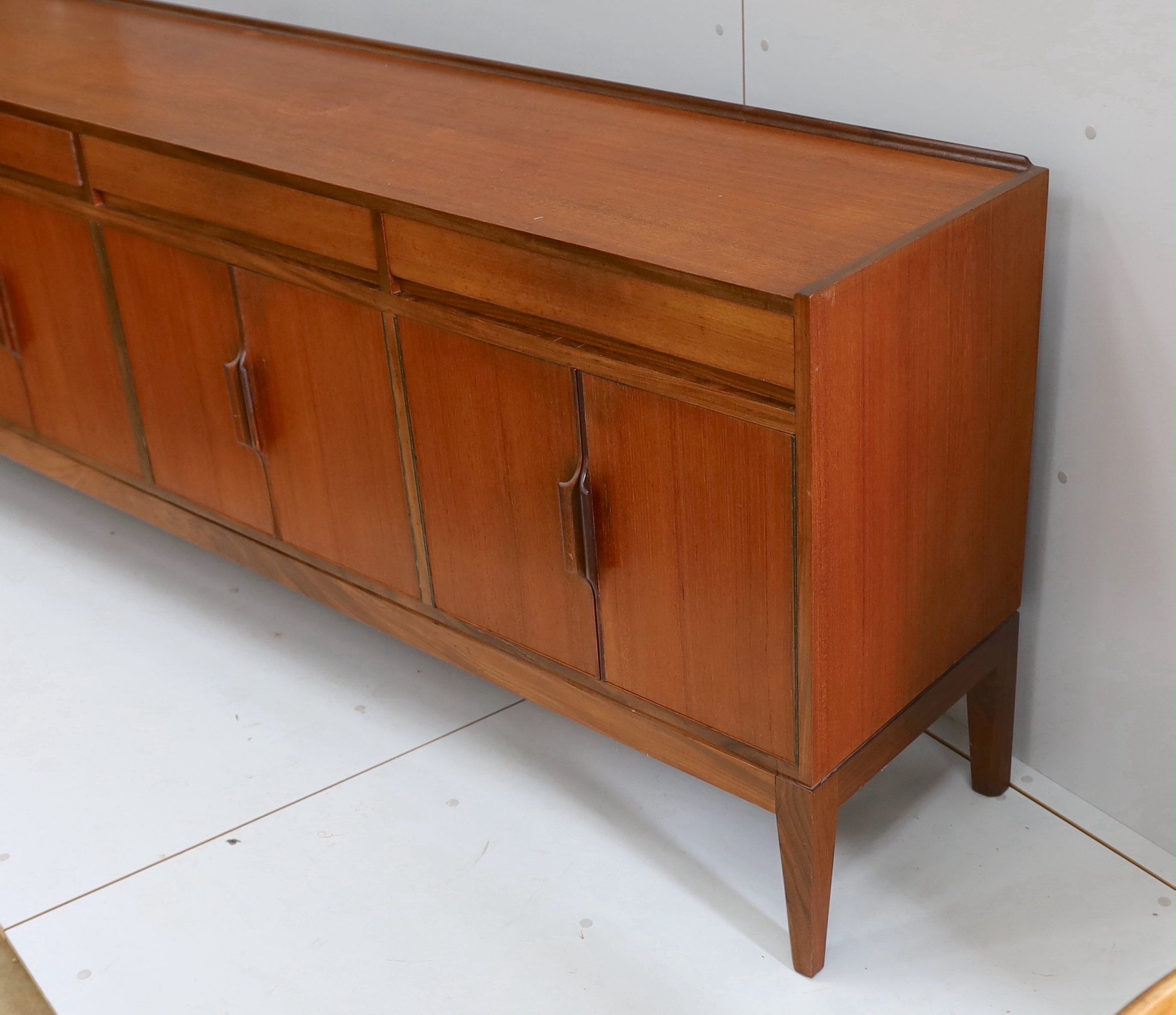 Robert Heritage for Archie Shine, a mid century teak sideboard, length 238cm, depth 46cm, height 86cm